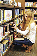 Alexa Lindquist looks through books at the new AJHS that opened in January. 