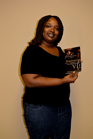 Savannah Odom is shown with her newly released book. 