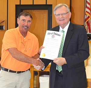 Gary Hutcheson of the District Attorney’s office is presented a commendation from Mayor Earl Johnson.  
