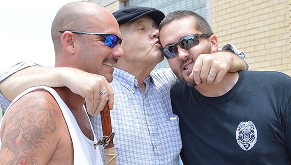Above: Bubba Bailey shows some love for Roger Cender and Nathan Frank during a fundraiser after his diagnosis. 