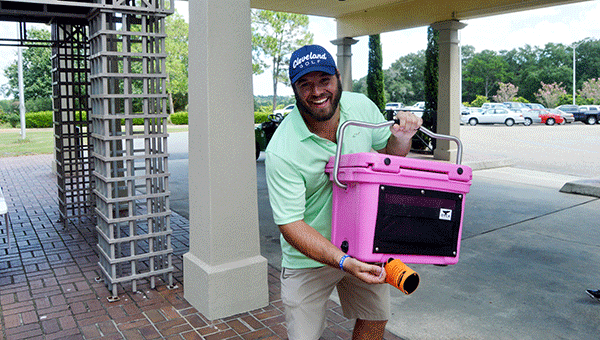 Tyler Centner poises with the cooler he won during the ball drop. Josh Dutton/Star-News