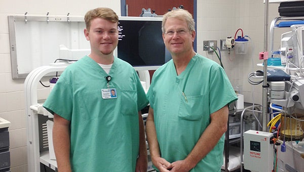 UA student Hampton Glenn with Dr. Tim Day in the operating room Wednesday morning. Courtesy photo 