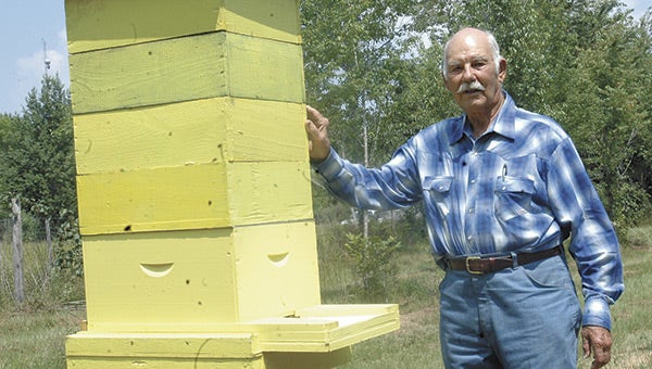 This 2010 file photo shows OJ Blount with one of his beehives.  File photo