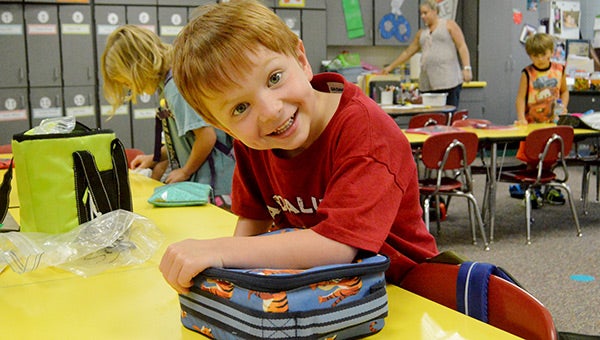 Jackson Grimes smiles big in his classroom. 