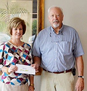 Andalusia Health Services President and Lions Club President Ivan Bishop received a donation from Andalusia Health Services member Carolyn Graham. The contribution will go to help the Andalusia Lions Club for its sight-related projects.
