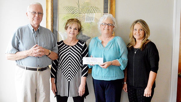Andalusia Health Services member Harmon Proctor presents Meredith’s Miracles directors June Simpson, Janna Marsh and Emily Yehling.