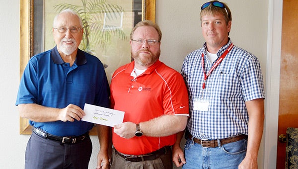 South Central Alabama Chapter of the American Red Cross members Kevin Kennedy and Steven Carr accept a contribution from Andalusia Health Services member Wayne Bennett. Kennedy said that the majority of the contribution would go to help Covington County families in disaster situations. 