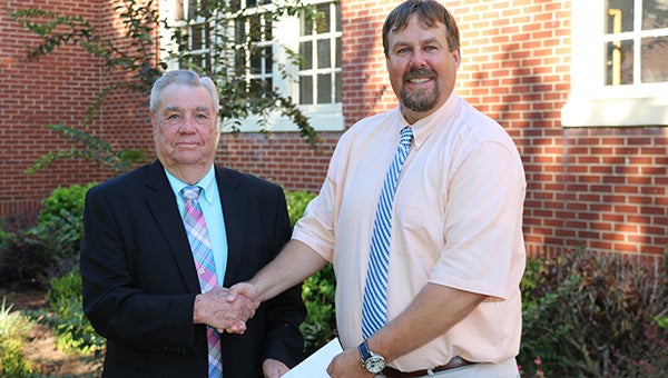 CEC Board Vice President Heflin Smith, left, recently presented teacher contributions from the cooperative to Fleeta School Principal Seth Richards, right.   teacher contributions.