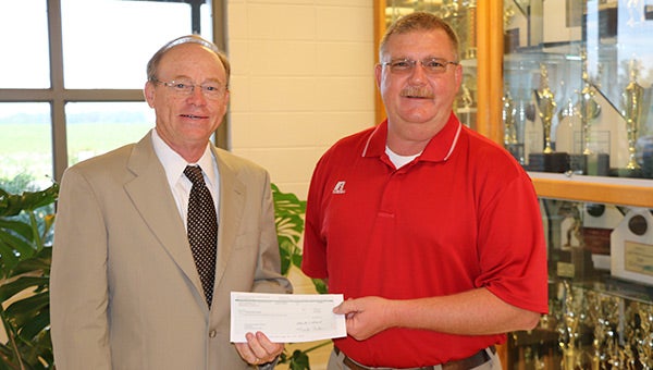 CEC Board member Dr. Bill King, left, recently presented teacher contributions from the cooperative to Pleasant Home School Principal Craig Nichols, right. These contributions are part of CEC’s ongoing commitment to education.