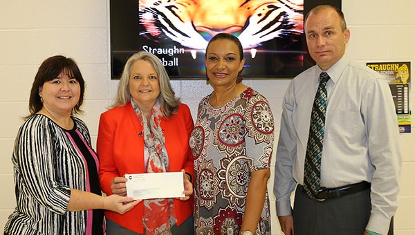 Pictured from left, CEC Vice President of Financial Services Kim Carter recently presented teacher contributions from the cooperative to Straughn Elementary School Principal Bettye Anne Older, Straughn Middle School Principal Cassandra Scott and Straughn High School Principal Donny Powell.