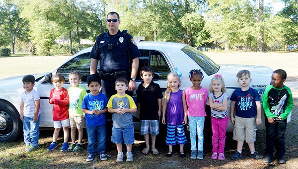The students from Bright Beginnings enjoyed hanging out with Andalusia Police Department officer Kevin Norris on Thursday as they learned about community helpers.  