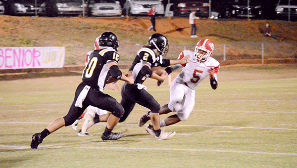 Colten Dorman charges up field on a fake put last week against Pleasant Home. Josh Dutton/Star-News
