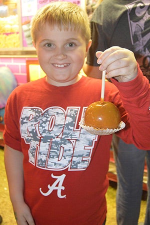 Haden Green, 10, chose a caramel apple. He came with his family from Greenville to enjoy the fair.