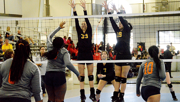 Baliee Boyd and Addie Jacobs go up for a block during the South Regional volleyball tournament.                                                                                          Josh Dutton/Star-News